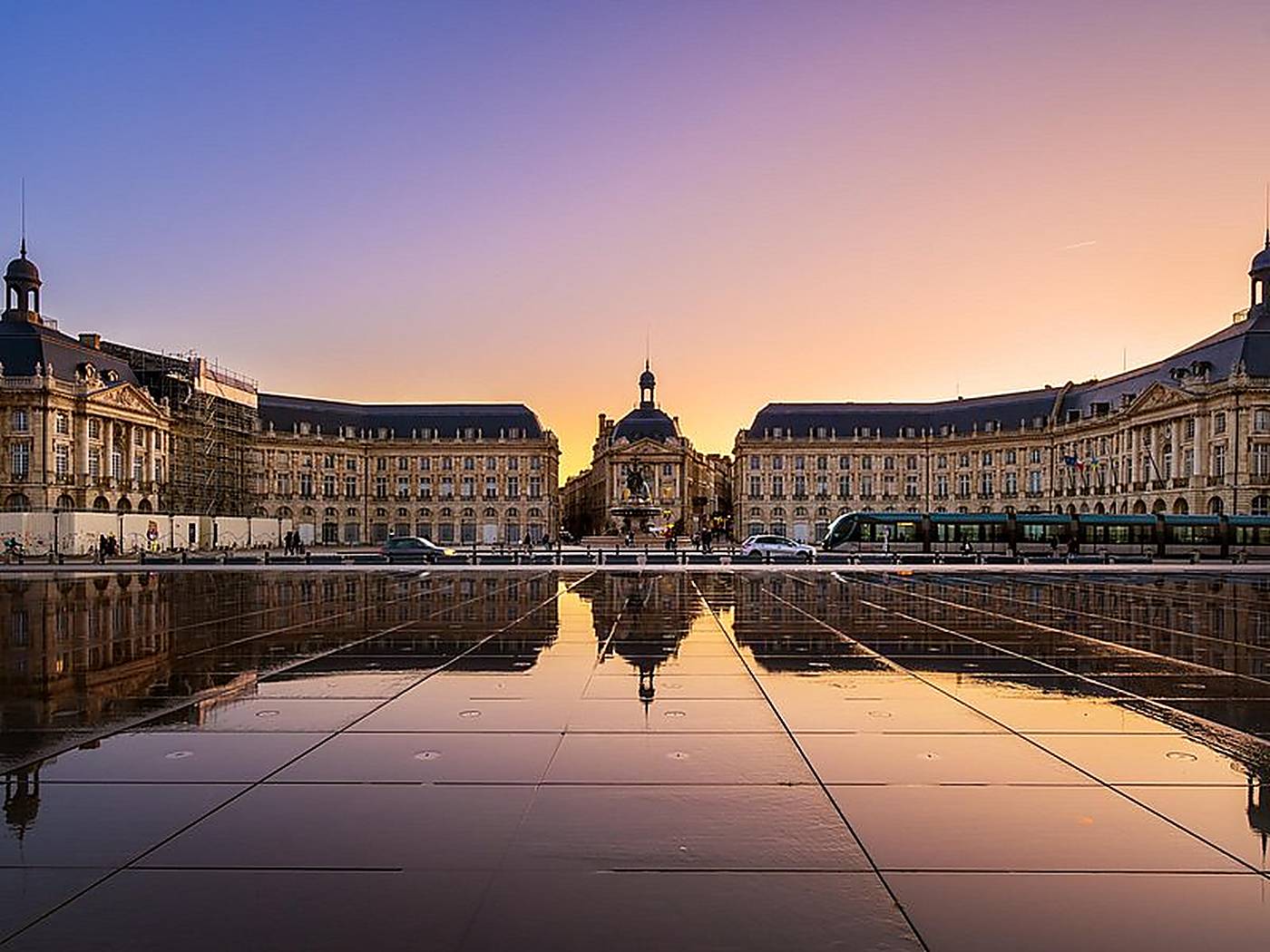 Place de la Bourse in Bordeaux at sunset, its façades mirrored in the water mirror